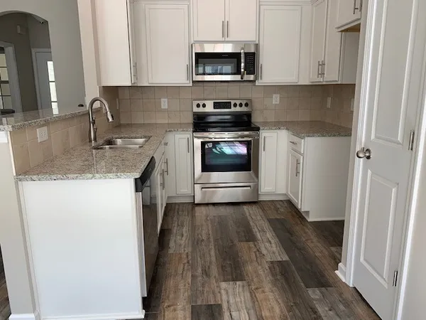 a kitchen with a sink and a stove top oven