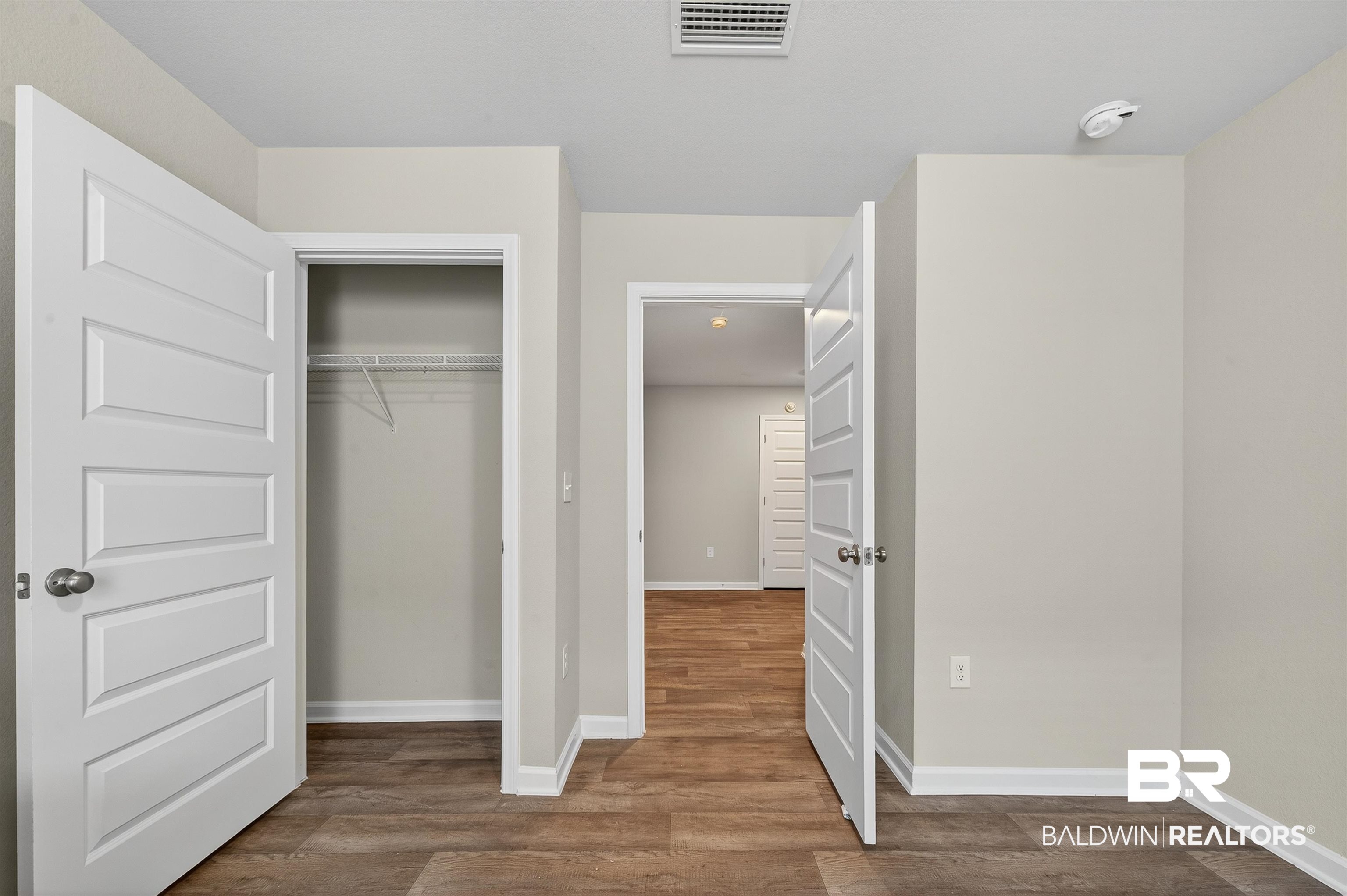 7429 Brompton Drive Foley, AL 36535 - Photo 44 of 50 Unfurnished bedroom featuring dark wood-style flooring and a closet