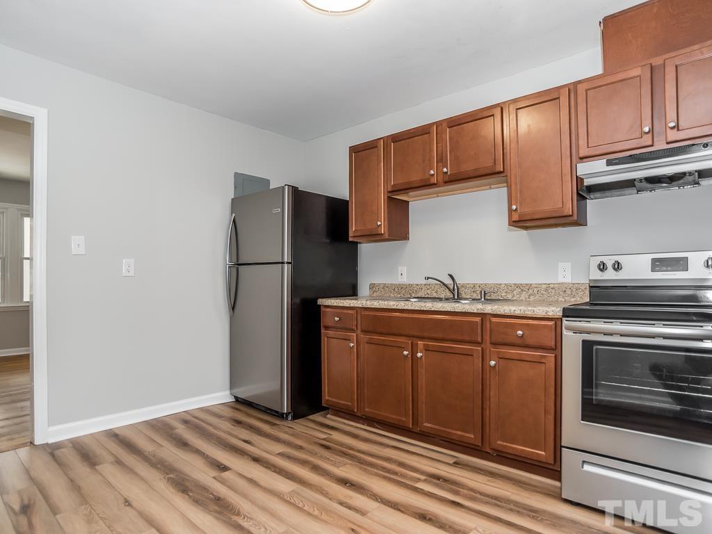 512 Dacian Road Raleigh, NC 27610 - Photo 15 of 19 a kitchen with stainless steel appliances granite countertop a refrigerator stove and cabinets