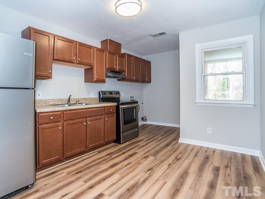 512 Dacian Road Raleigh, NC 27610 - Photo 16 of 19 a kitchen with stainless steel appliances granite countertop a stove a sink and a refrigerator