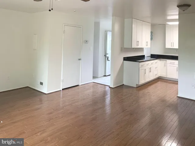 a view of kitchen with granite countertop cabinets and wooden floor