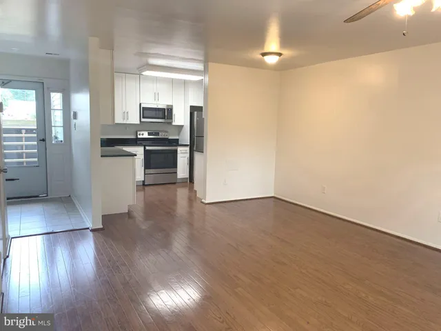 a kitchen with stainless steel appliances a refrigerator and a stove top oven