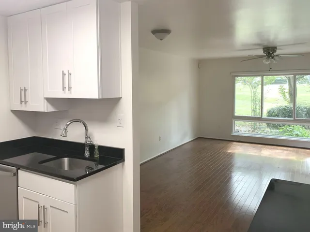 a kitchen with granite countertop a sink and a stove