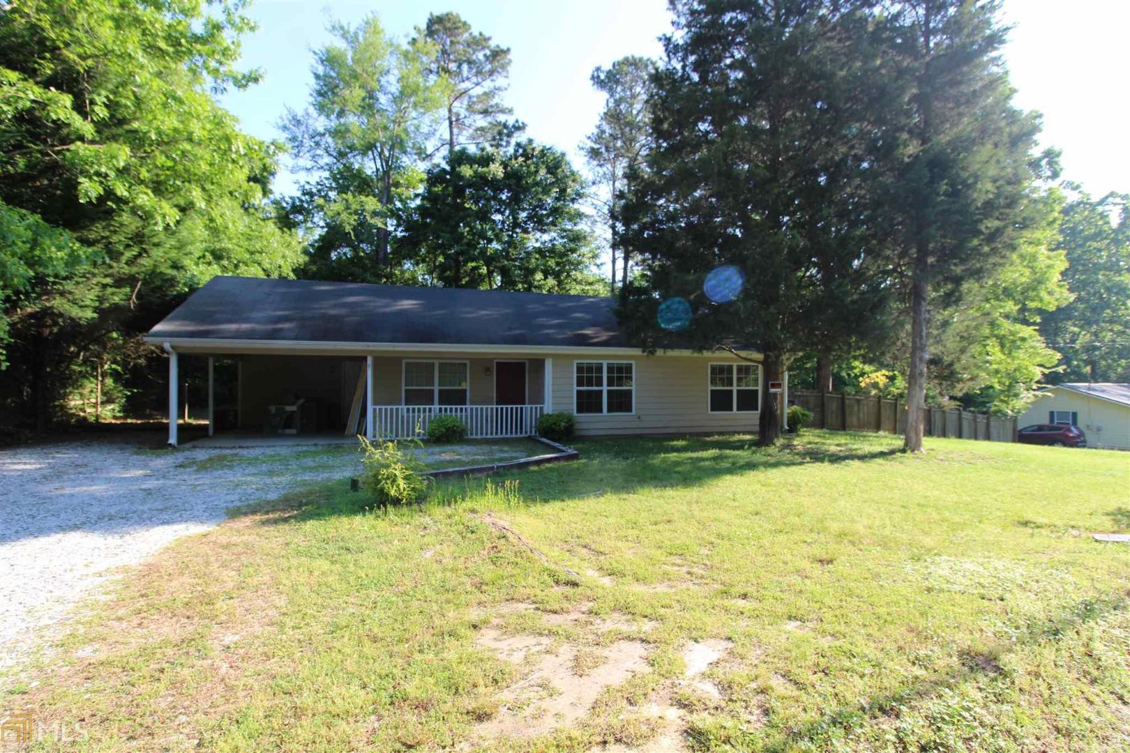 a front view of a house with a yard and trees