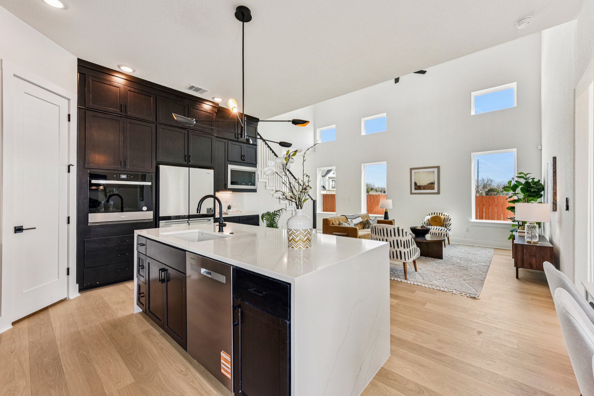 12105 Cearley Drive Austin, TX 78758 - Photo 39 of 40 a open kitchen with stainless steel appliances kitchen island a sink and wooden floor