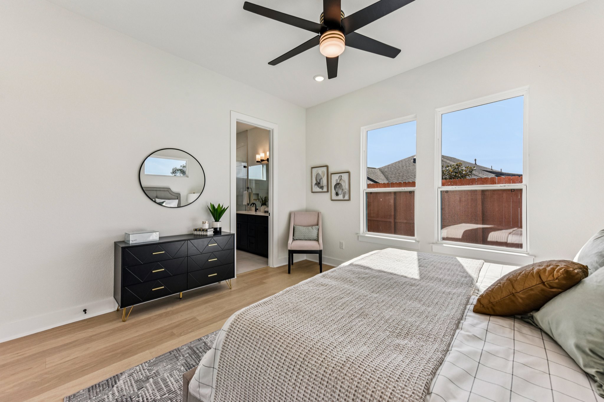 12105 Cearley Drive Austin, TX 78758 - Photo 14 of 40 a bedroom with a bed window and a chandelier