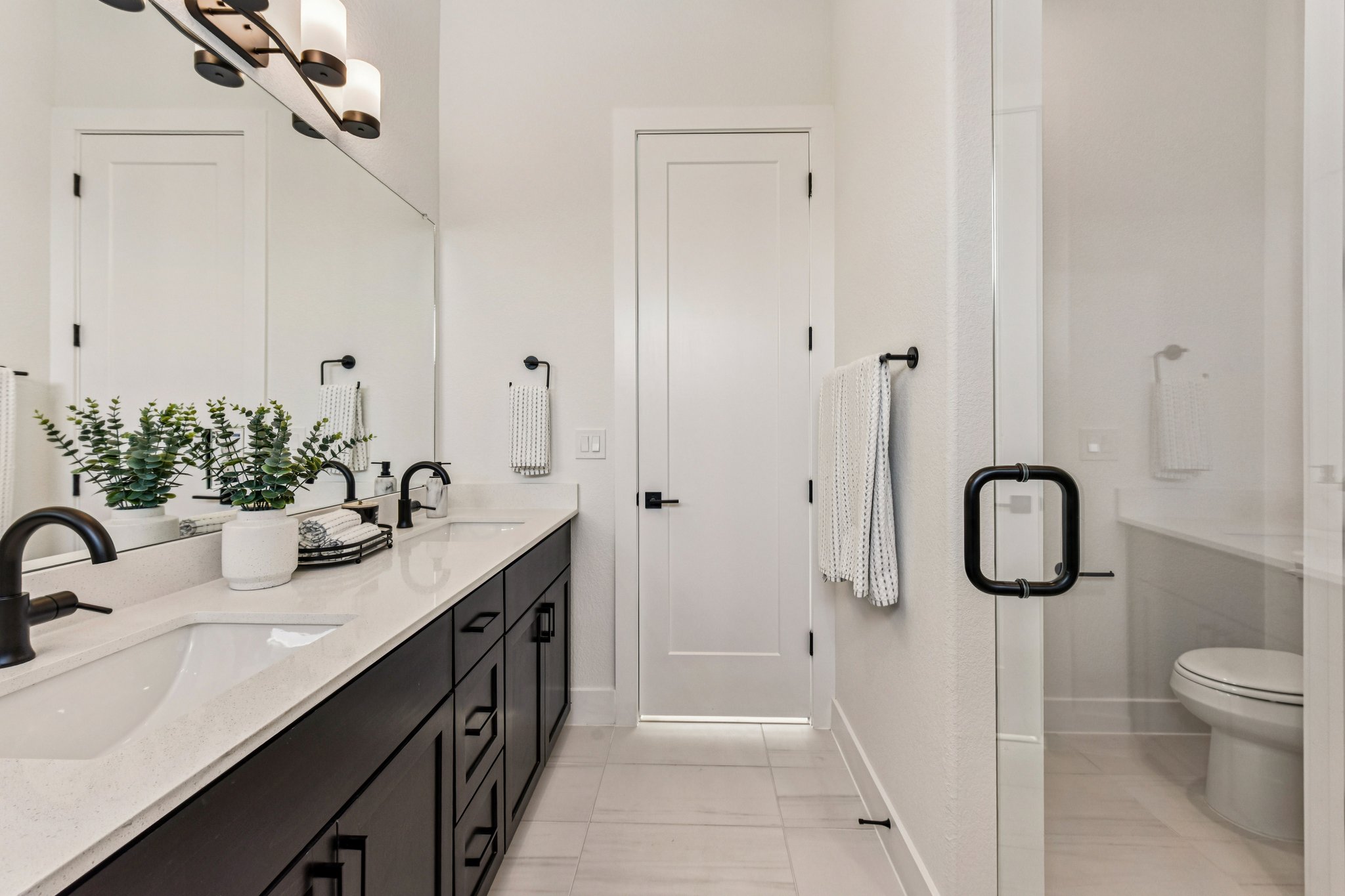 12105 Cearley Drive Austin, TX 78758 - Photo 18 of 40 a bathroom with a granite countertop sink a toilet and shower