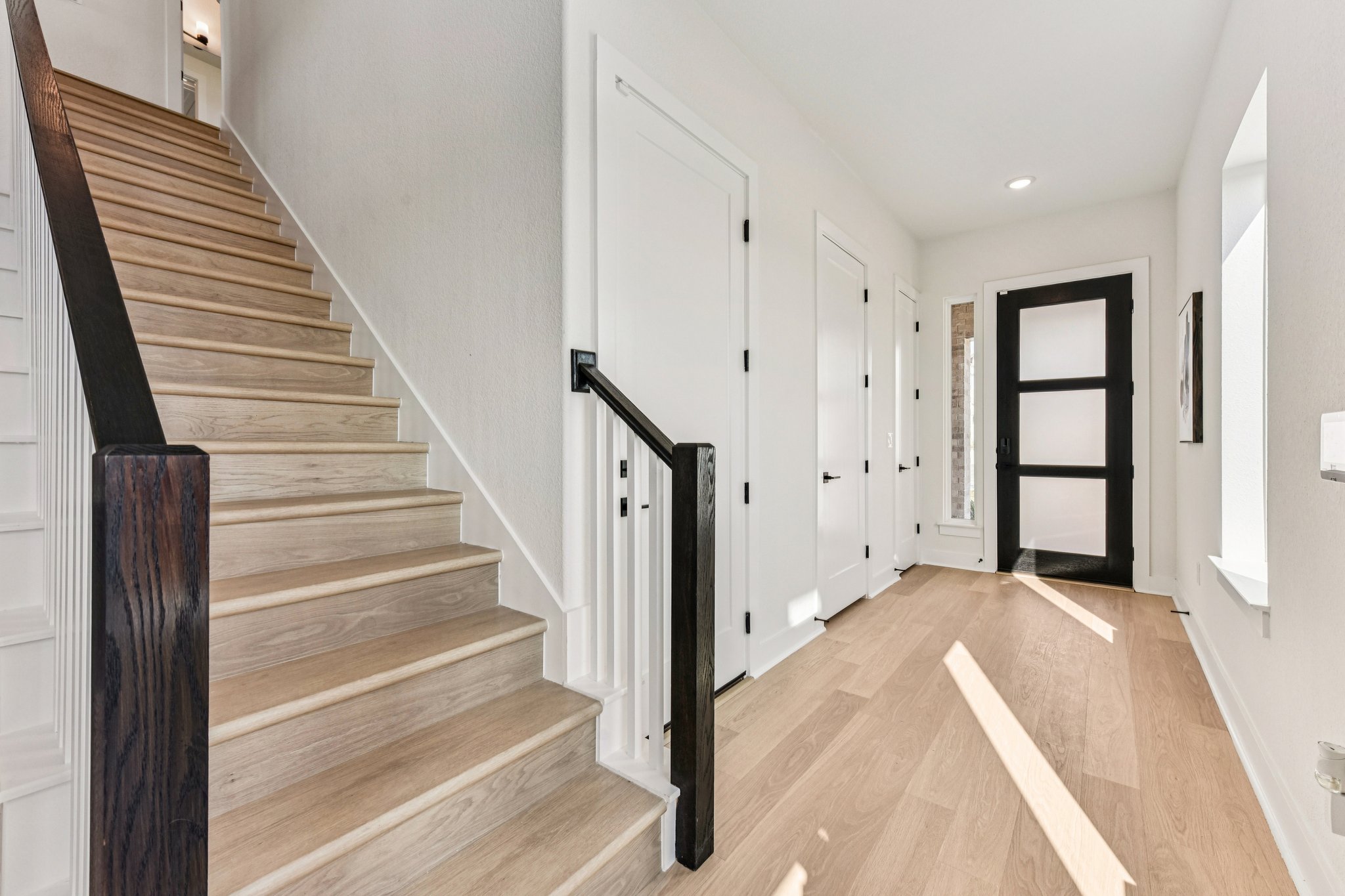 12105 Cearley Drive Austin, TX 78758 - Photo 2 of 40 a view of a hallway with wooden floor and entryway