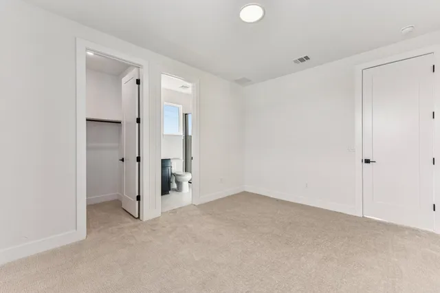 a view of a dining room with furniture and a potted plant
