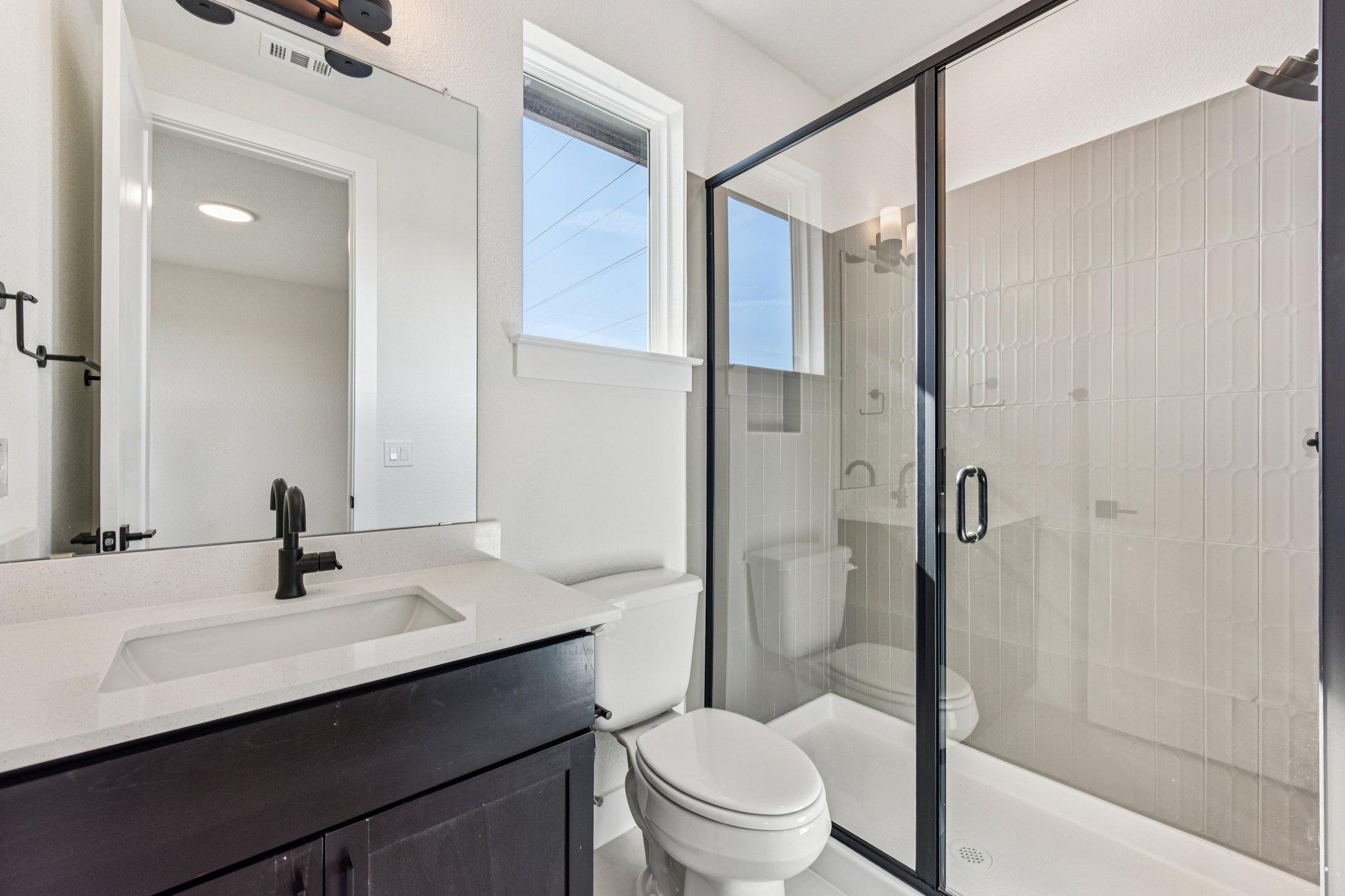 12105 Cearley Drive Austin, TX 78758 - Photo 27 of 40 a bathroom with a sink a toilet and shower