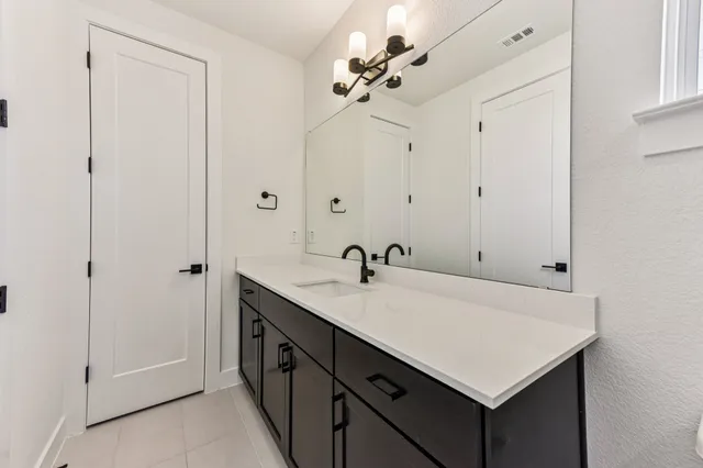 a bathroom with a sink vanity and a mirror