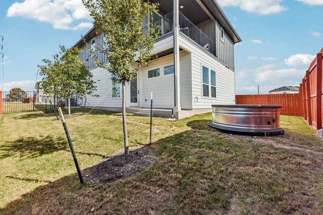 a view of a house with backyard and sitting area