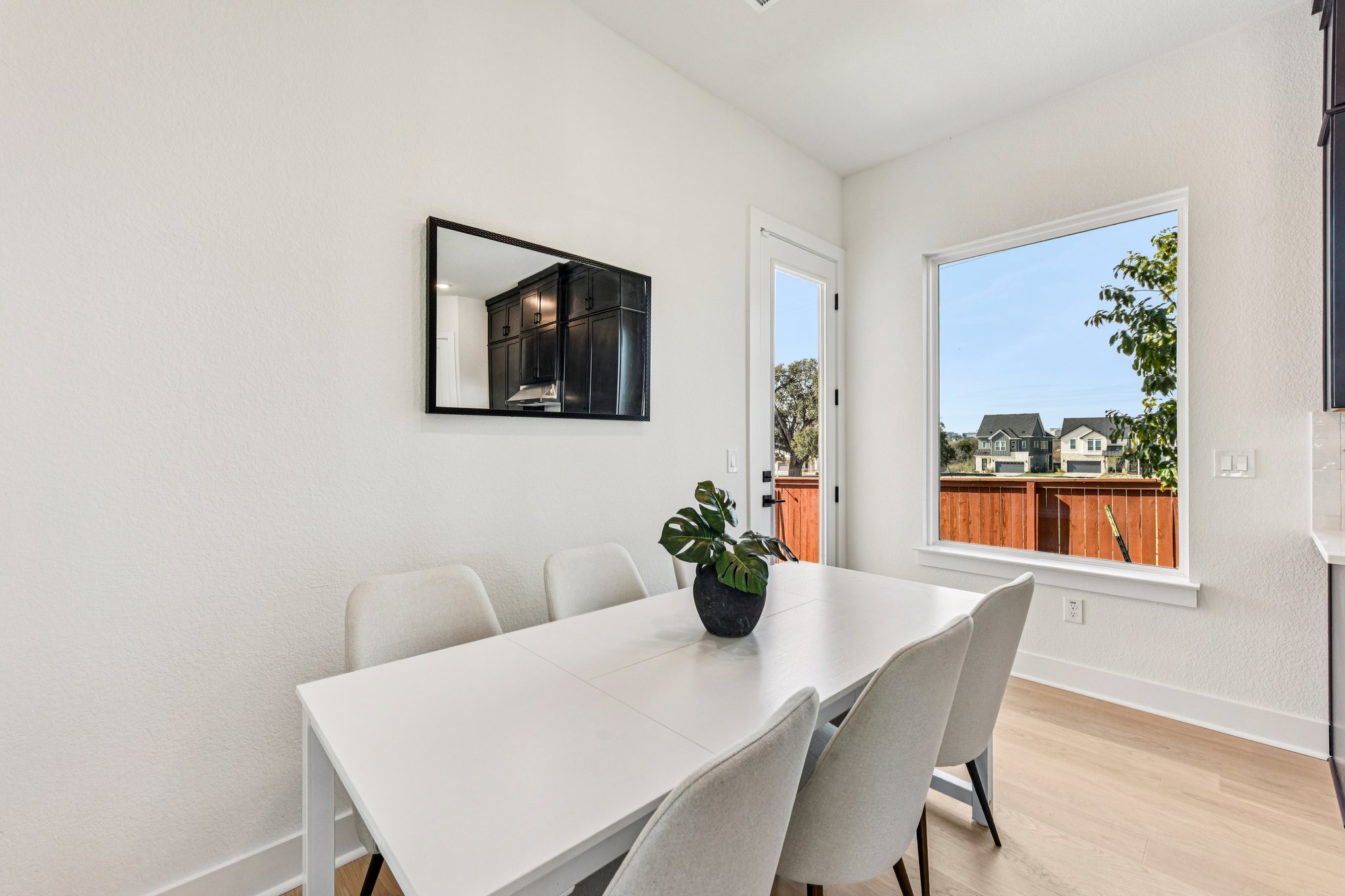 12105 Cearley Drive Austin, TX 78758 - Photo 7 of 40 a view of a dining room with furniture window and wooden floor