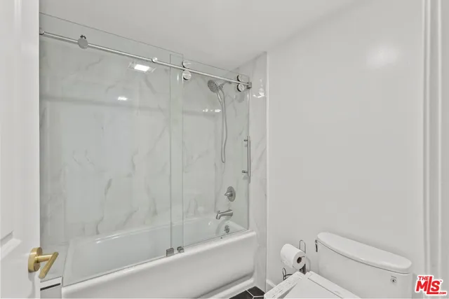 a bathroom with a shower and a toilet