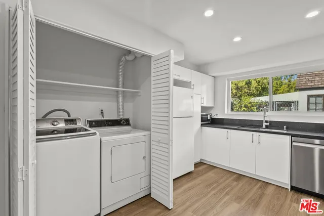a kitchen with a sink and wooden cabinets
