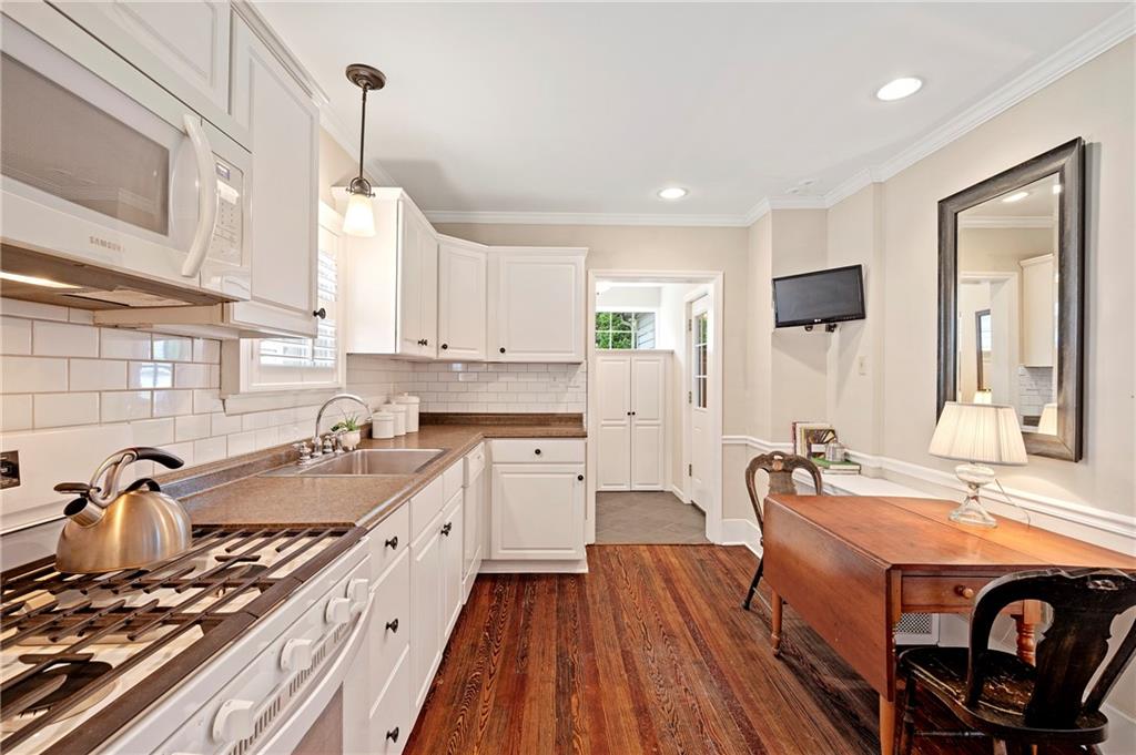 212 Pine Road Sewickley, PA 15143 - Photo 12 of 33 Bright, updated kitchen with white cabinetry, subway tile backsplash, and hardwood floors for a clean, classic look. Thoughtful layout includes space for casual dining and efficient flow for everyday living.