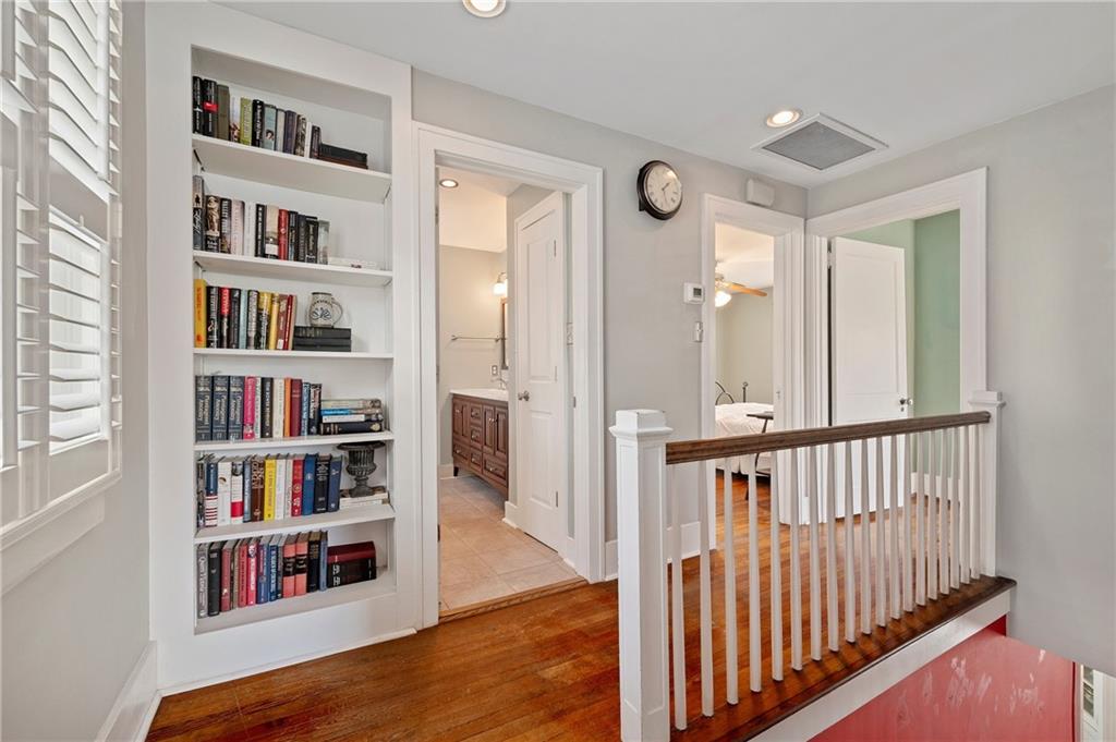 212 Pine Road Sewickley, PA 15143 - Photo 16 of 33 The second-floor hallway features hardwood floors and a built-in bookshelf that adds both character and practical storage. The layout connects easily to the bedrooms and bath, supporting a smooth, functional daily routine.