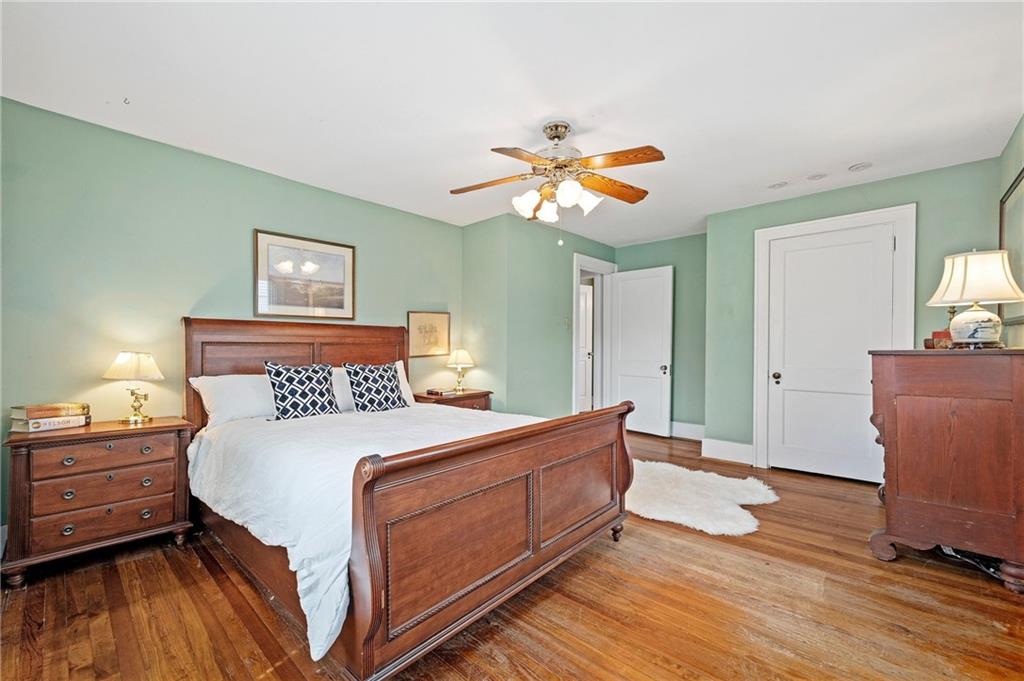 212 Pine Road Sewickley, PA 15143 - Photo 17 of 33 The primary bedroom offers hardwood floors, generous space, and a calm, comfortable setting for rest and retreat.