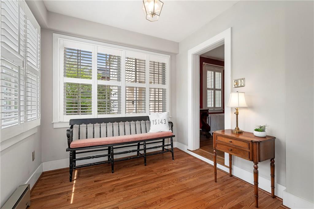 212 Pine Road Sewickley, PA 15143 - Photo 4 of 33 Sun-filled entry foyer with hardwood floors and large windows with plantation shutters, creating a bright and welcoming first impression.