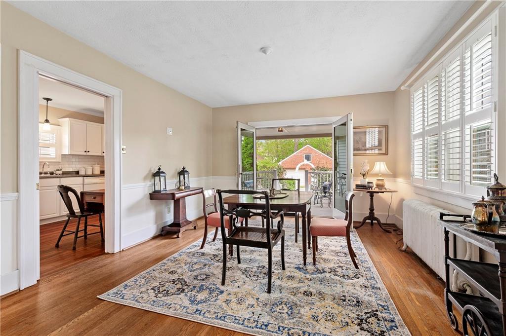 212 Pine Road Sewickley, PA 15143 - Photo 7 of 33 Warm, inviting dining space with hardwood floors and classic built-in cabinetry for added character and storage. French doors extend the living experience outdoors, perfect for everyday meals or hosting gatherings.