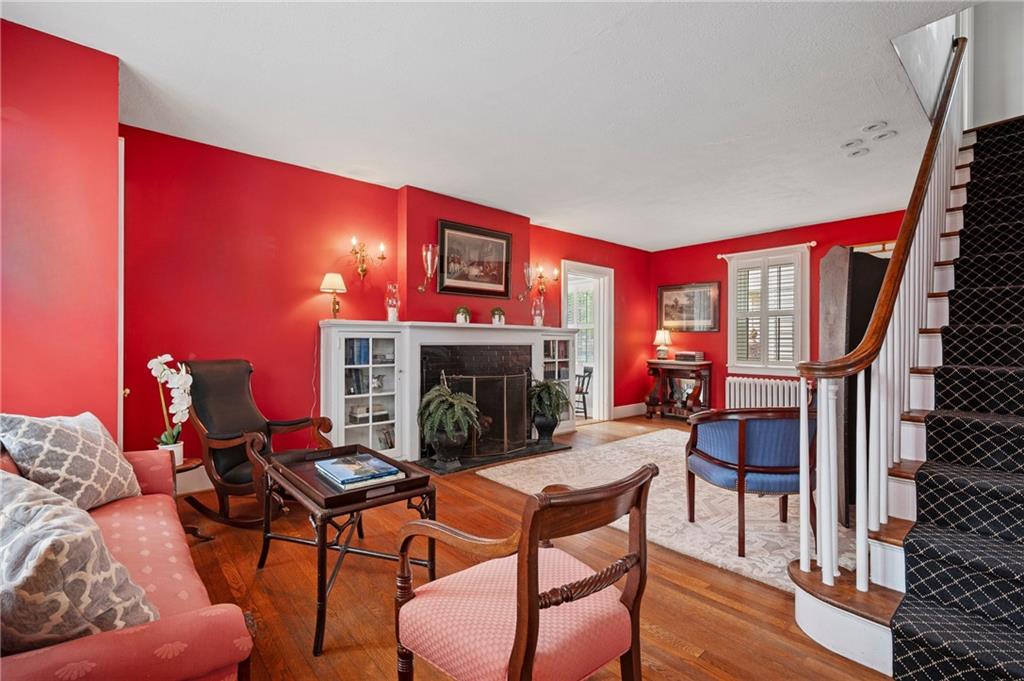 212 Pine Road Sewickley, PA 15143 - Photo 9 of 33 Inviting living space centered around a fireplace with built-in shelving and classic mantel detail. A natural gathering spot that encourages conversation, reading, and relaxed evenings at home.