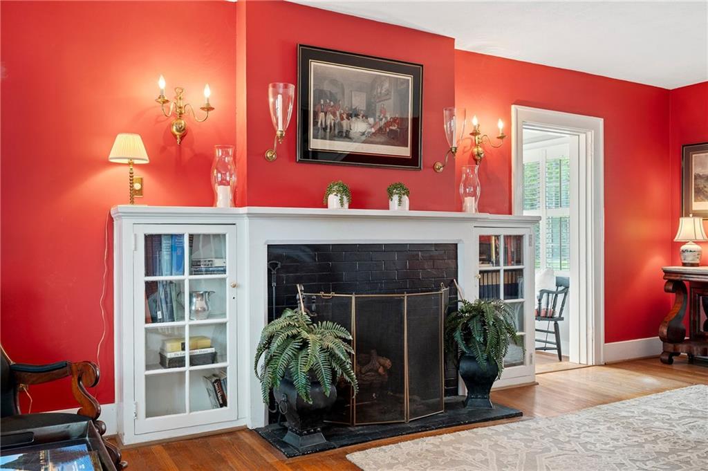 212 Pine Road Sewickley, PA 15143 - Photo 10 of 33 Charming fireplace with classic mantel and built-in shelving creates a warm focal point for the room. Perfect for cozy nights in, adding character and comfort to everyday living.
