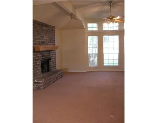 a view of an empty room with a fireplace