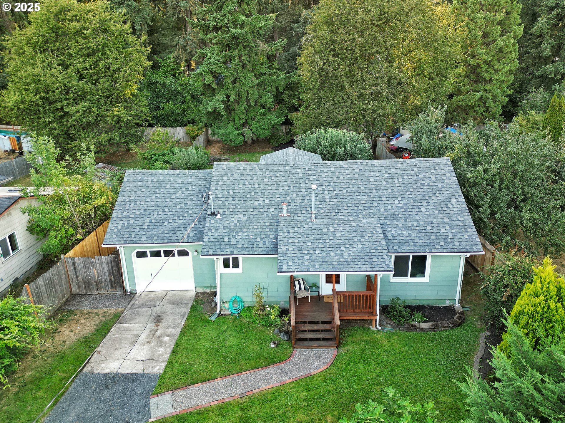 a aerial view of a house with a yard table and chairs