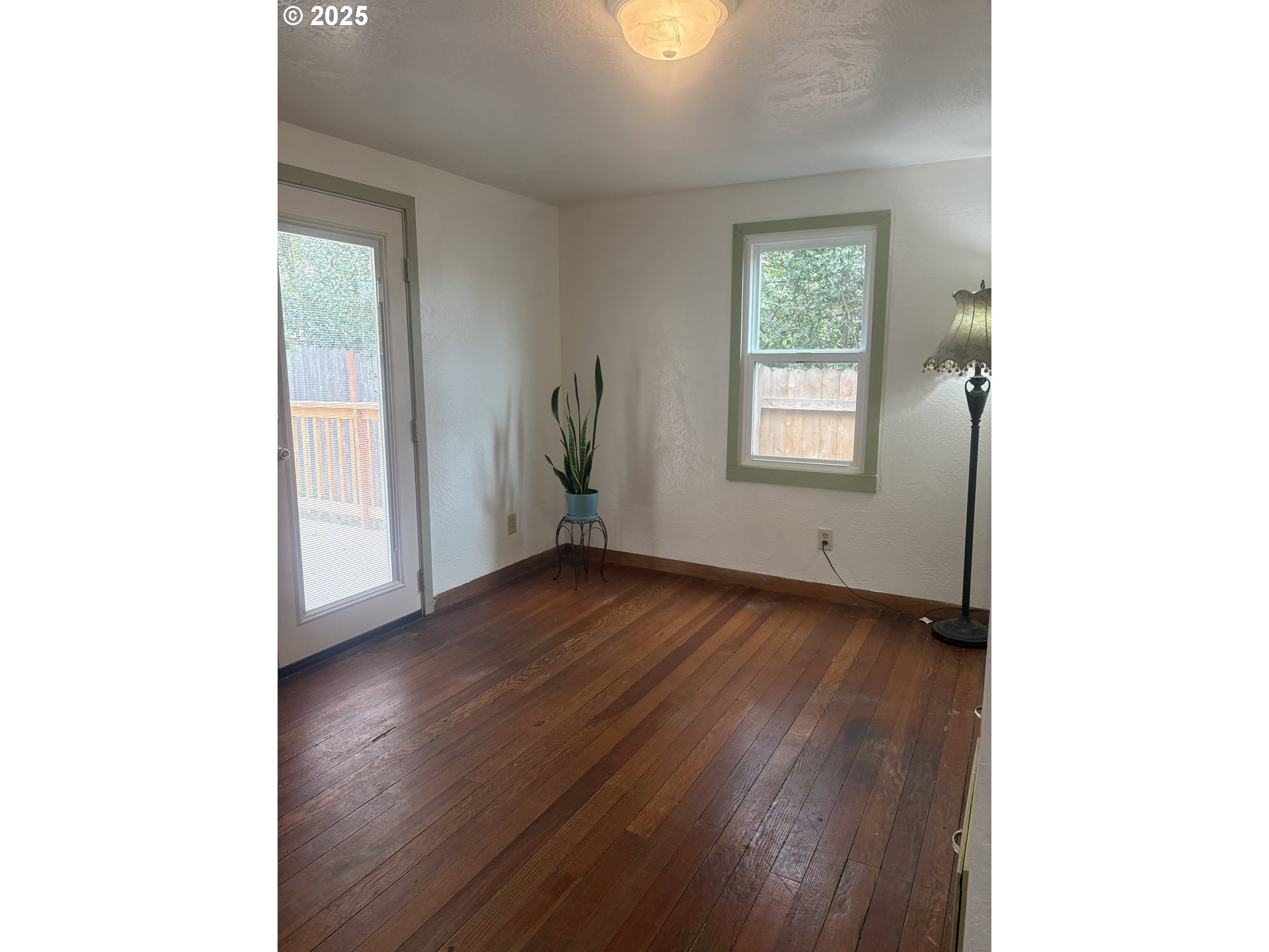 1730 Augusta Street Eugene, OR 97403 - Photo 6 of 11 a view of an empty room with wooden floor and a window