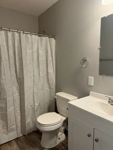 a white toilet sitting next to a bathroom sink