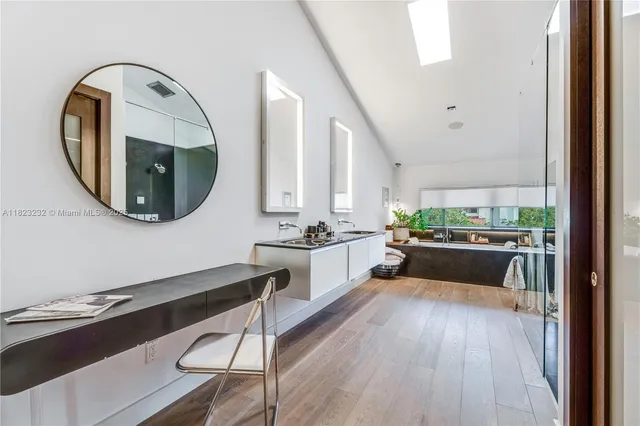 a large white kitchen with a large window