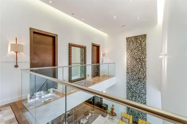 a view of a hallway with furniture and wooden floor