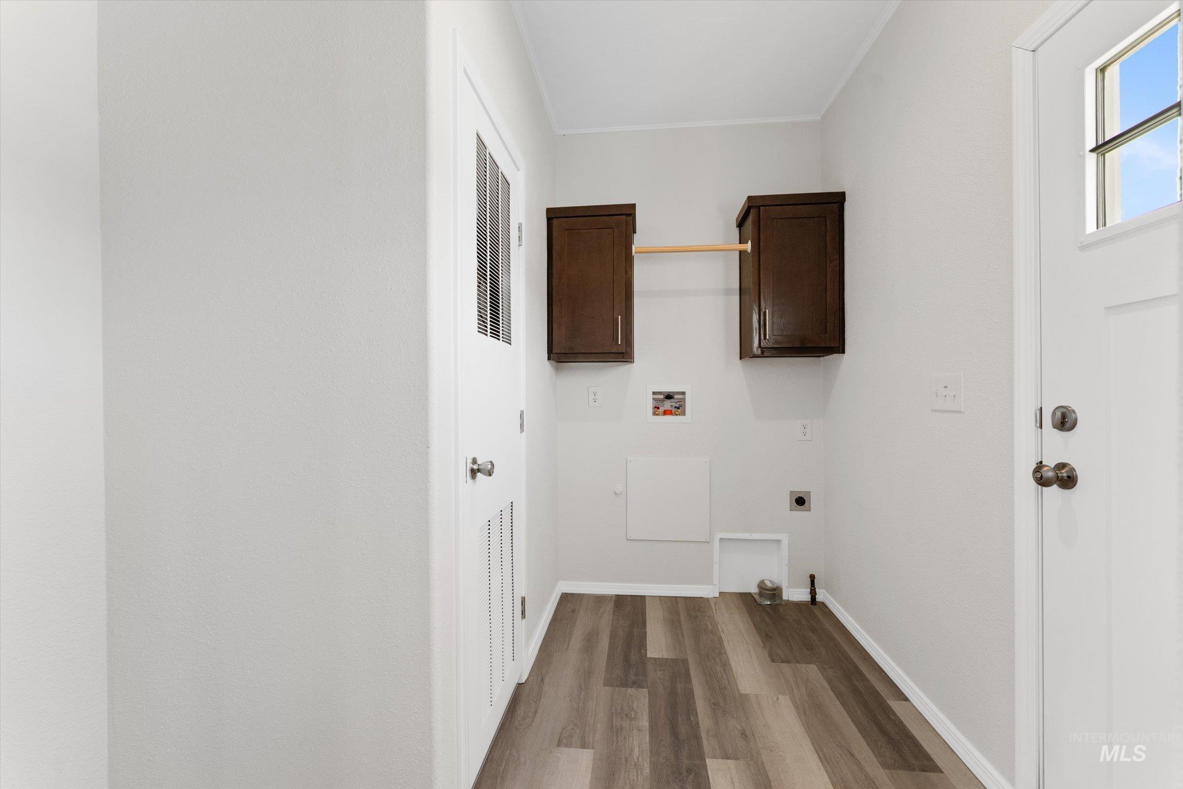 421 South Curtis Road, Unit 34 34 Boise, ID 83705 - Photo 11 of 22 Laundry area with cabinet space, dark wood-type flooring, hookup for a washing machine, and electric dryer hookup