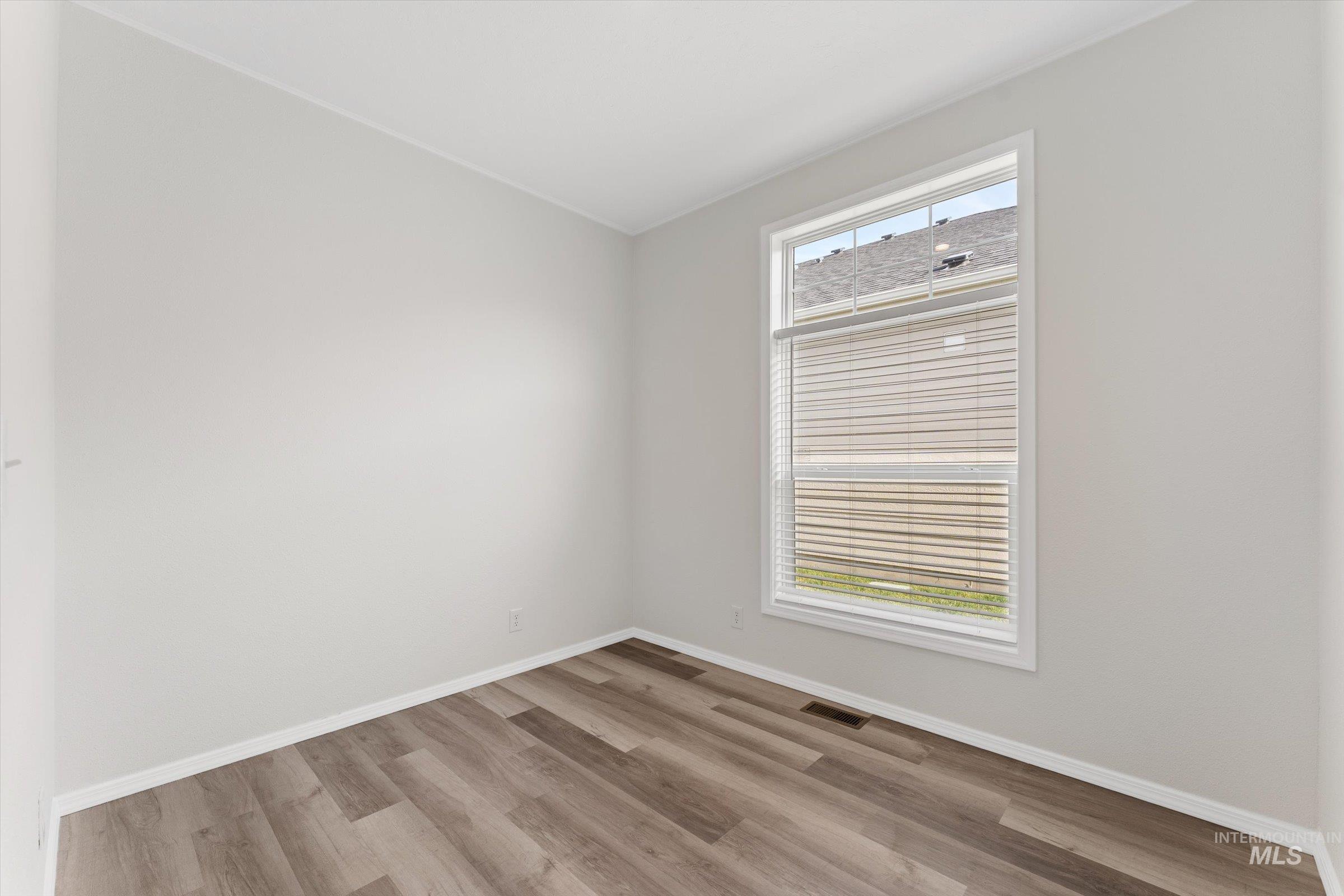 421 South Curtis Road, Unit 34 34 Boise, ID 83705 - Photo 12 of 22 Empty room with light wood finished floors and baseboards