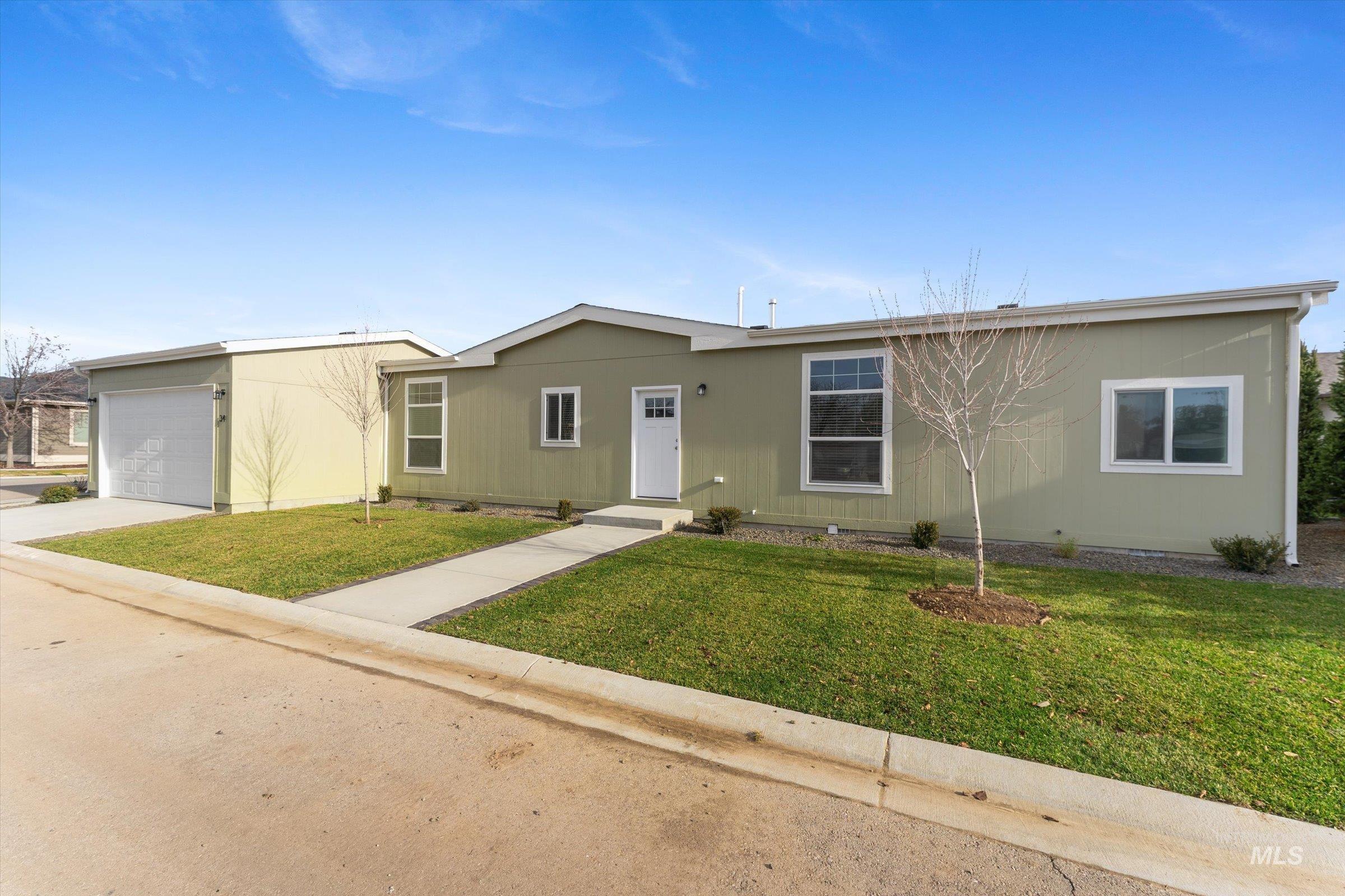 421 South Curtis Road, Unit 34 34 Boise, ID 83705 - Photo 2 of 22 Single story home featuring a front yard, driveway, and an attached garage