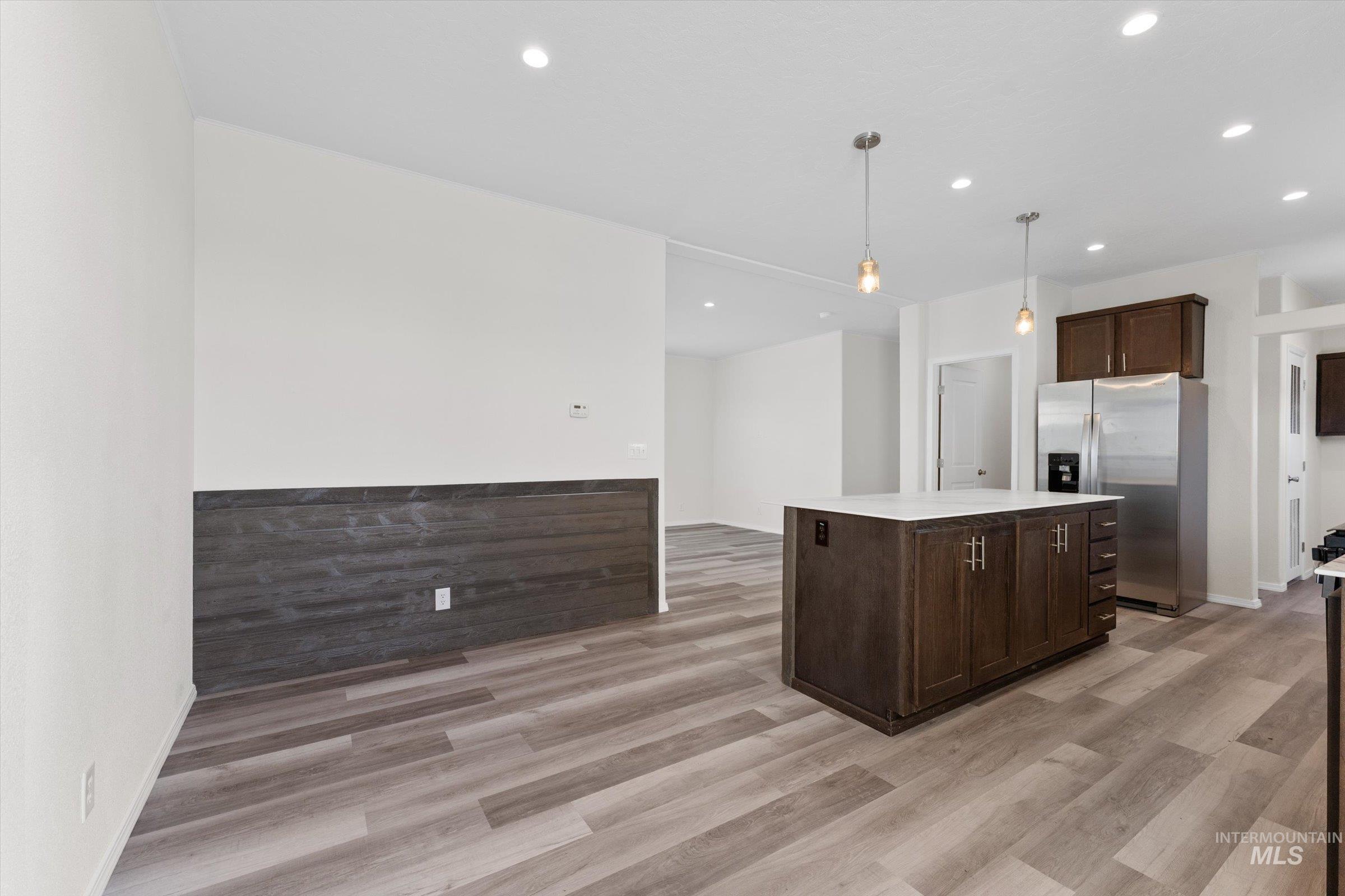 421 South Curtis Road, Unit 34 34 Boise, ID 83705 - Photo 7 of 22 Kitchen featuring stainless steel fridge with ice dispenser, decorative light fixtures, dark brown cabinetry, a kitchen island, and recessed lighting