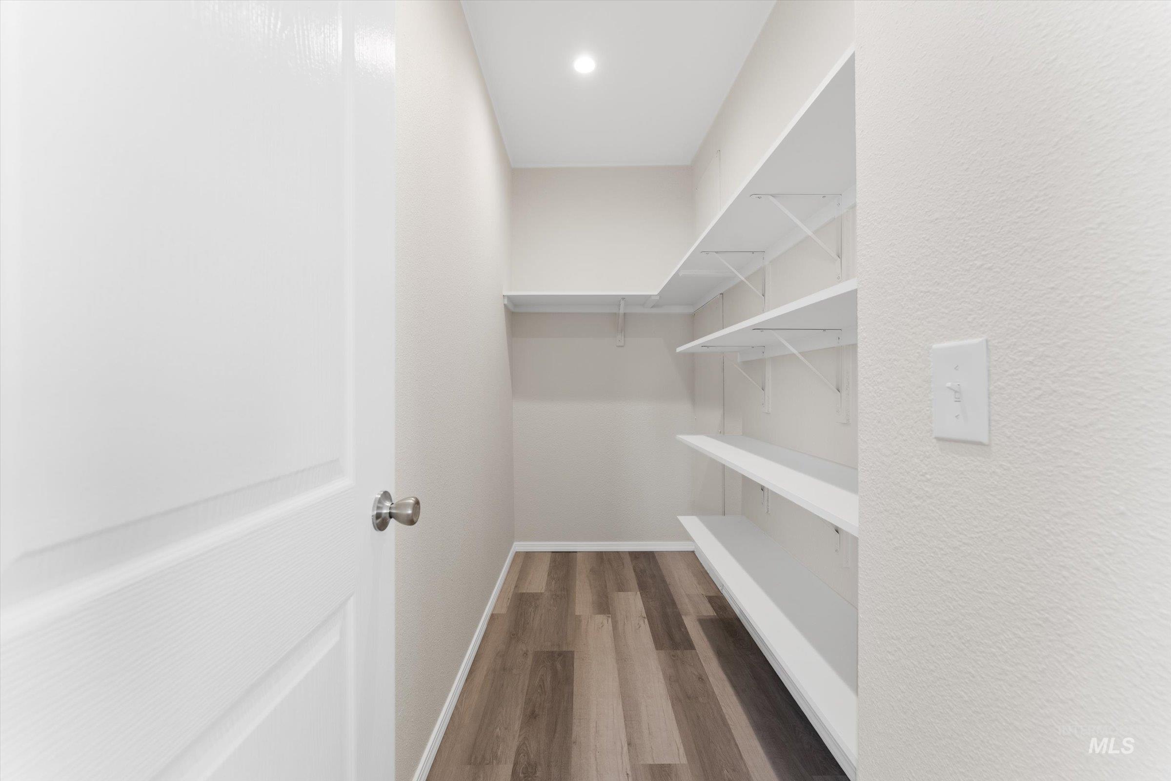 421 South Curtis Road, Unit 34 34 Boise, ID 83705 - Photo 9 of 22 Walk in closet with dark wood finished floors