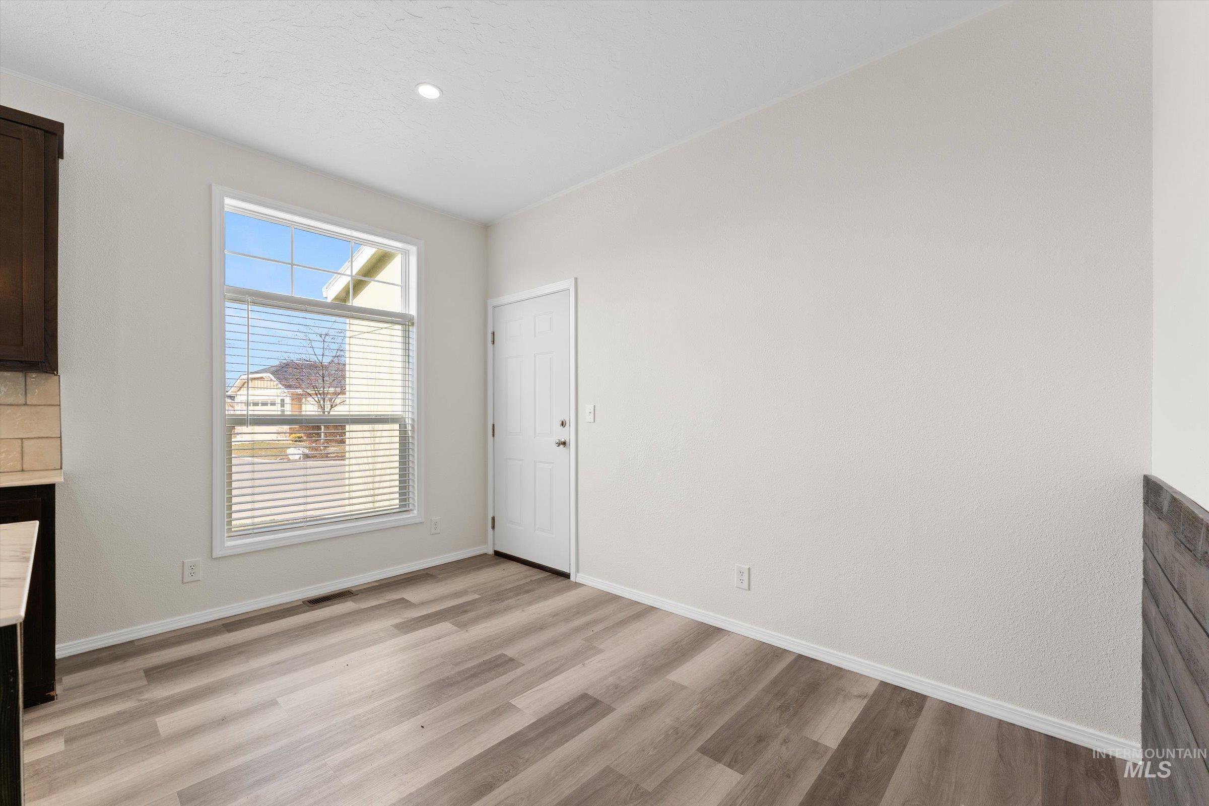 421 South Curtis Road, Unit 34 34 Boise, ID 83705 - Photo 10 of 22 Unfurnished dining area featuring light wood-style flooring and baseboards