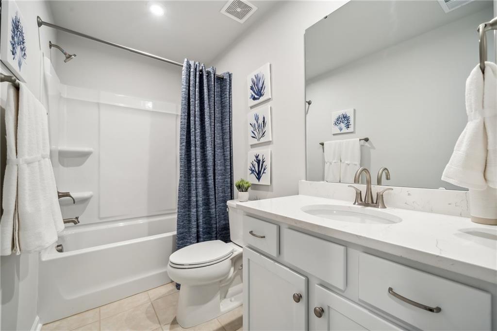 318 Cavalier Lane Acworth, GA 30102 - Photo 17 of 47 a bathroom with a sink a toilet and a large mirror