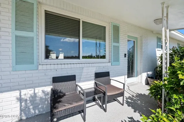 a backyard of a house with outdoor seating