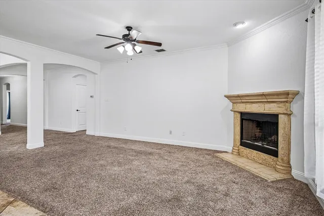 an empty room with a fireplace and fan