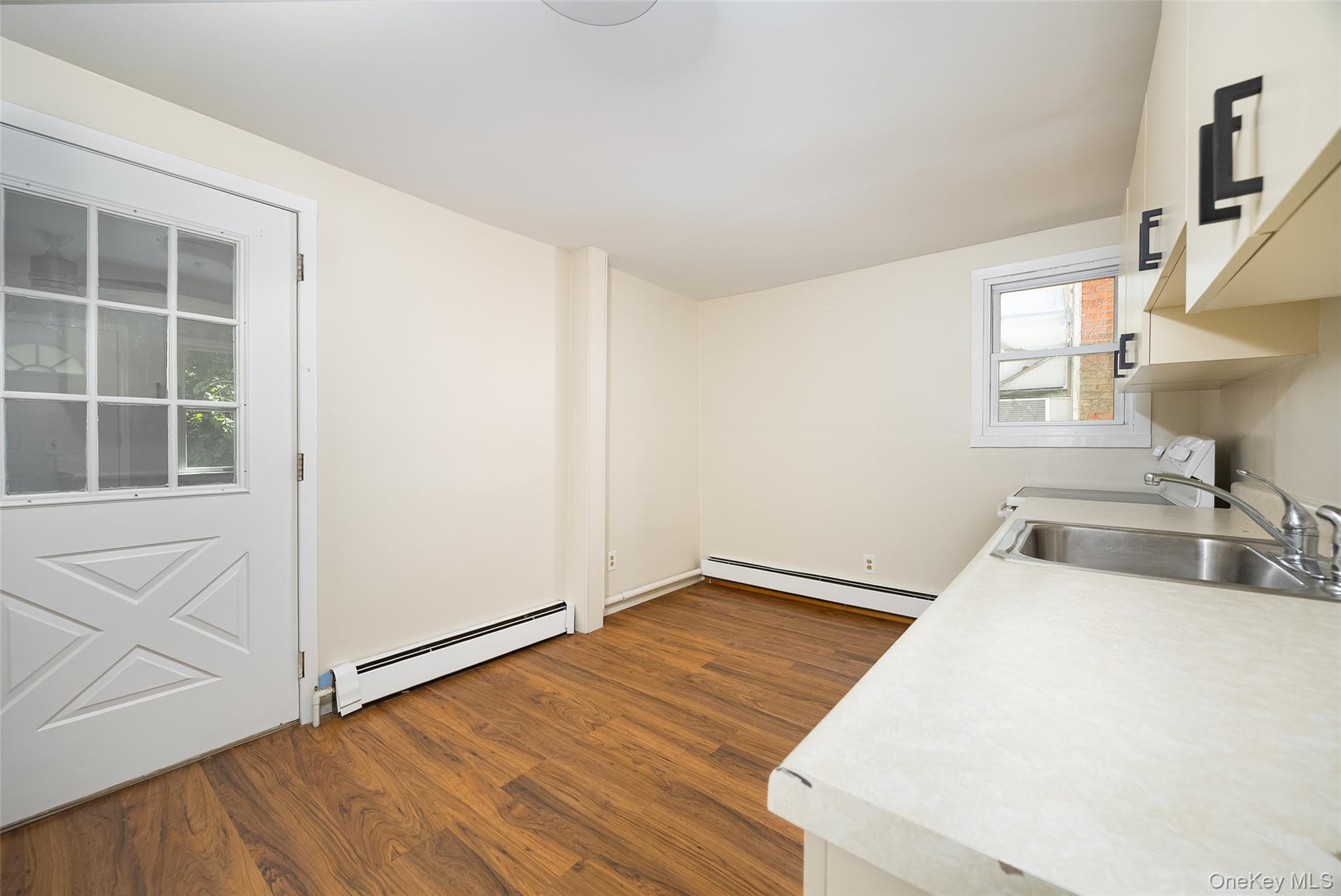 29 Delano Street, Unit 2 Poughkeepsie, NY 12601 - Photo 4 of 16 a view of a kitchen with wooden floor and staircase