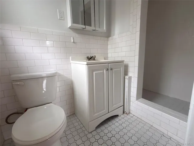 a white toilet sitting next to a bathroom sink