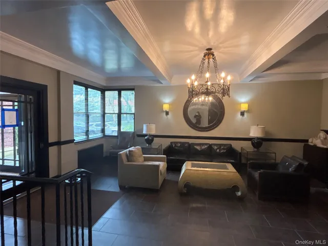 a room with furniture a chandelier and a window