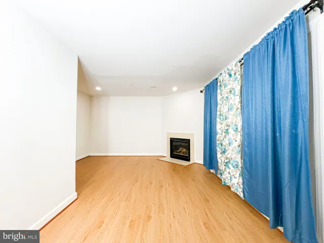 a spacious bedroom with a bed and a window