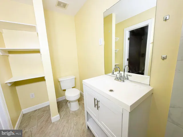 a view of bathroom with a sink and mirror