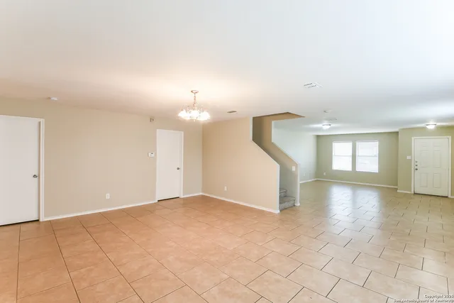 an empty room with windows and pillars in it