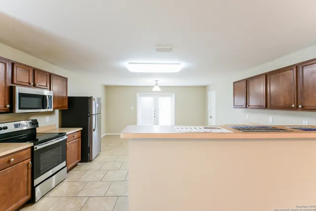 a kitchen with stainless steel appliances granite countertop a sink and a stove top oven with granite countertops