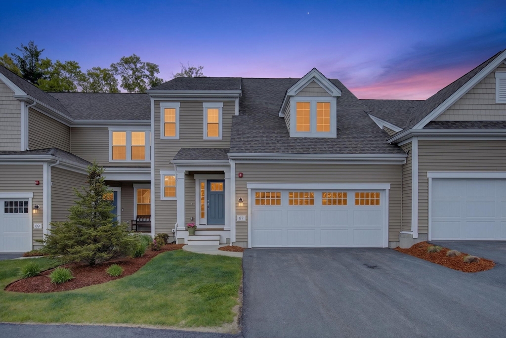 87 Shannon Way, Unit 86 Upton, MA 01568 - Photo 1 of 36 a front view of a house with a yard and garage