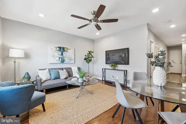 a living room with furniture and a wooden floor